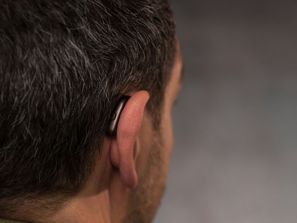 Doctor of Audiology programming a new hearing aid during a fitting appointment at Optimum Audiology in Apple Valley, CA