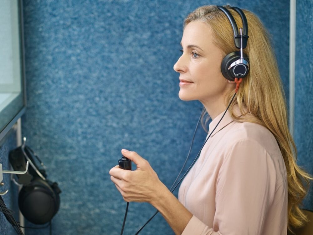 Veteran's hearing test in a sound booth at Optimum Audiology in the High Desert