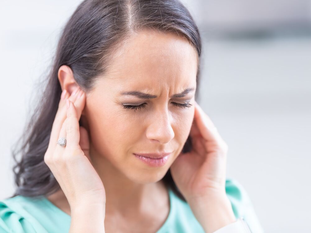 Patient discussing ringing in the ears with a Doctor of Audiology during a tinnitus evaluation at Optimum Audiology in Apple Valley, CA