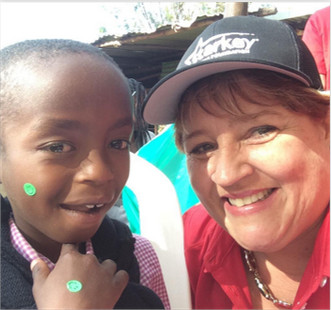 Dr. Mendoza with a child in Kenya